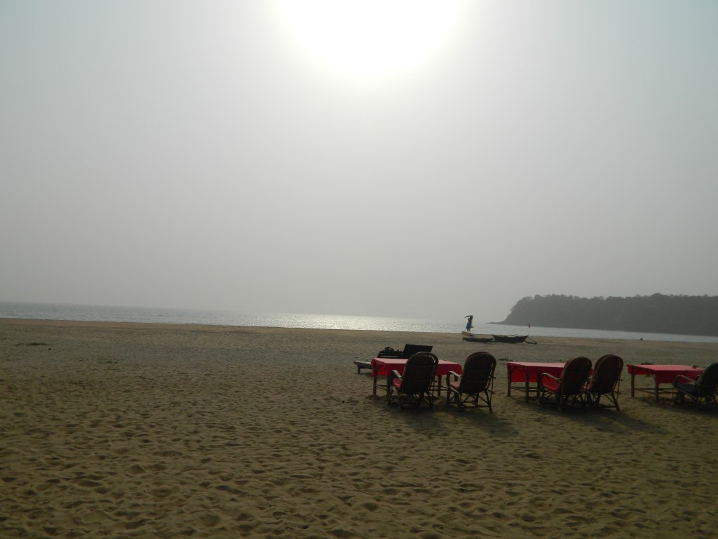 Agonda Beach in South Goa, with a broad sandy shoreline, calm sea and beach seating.